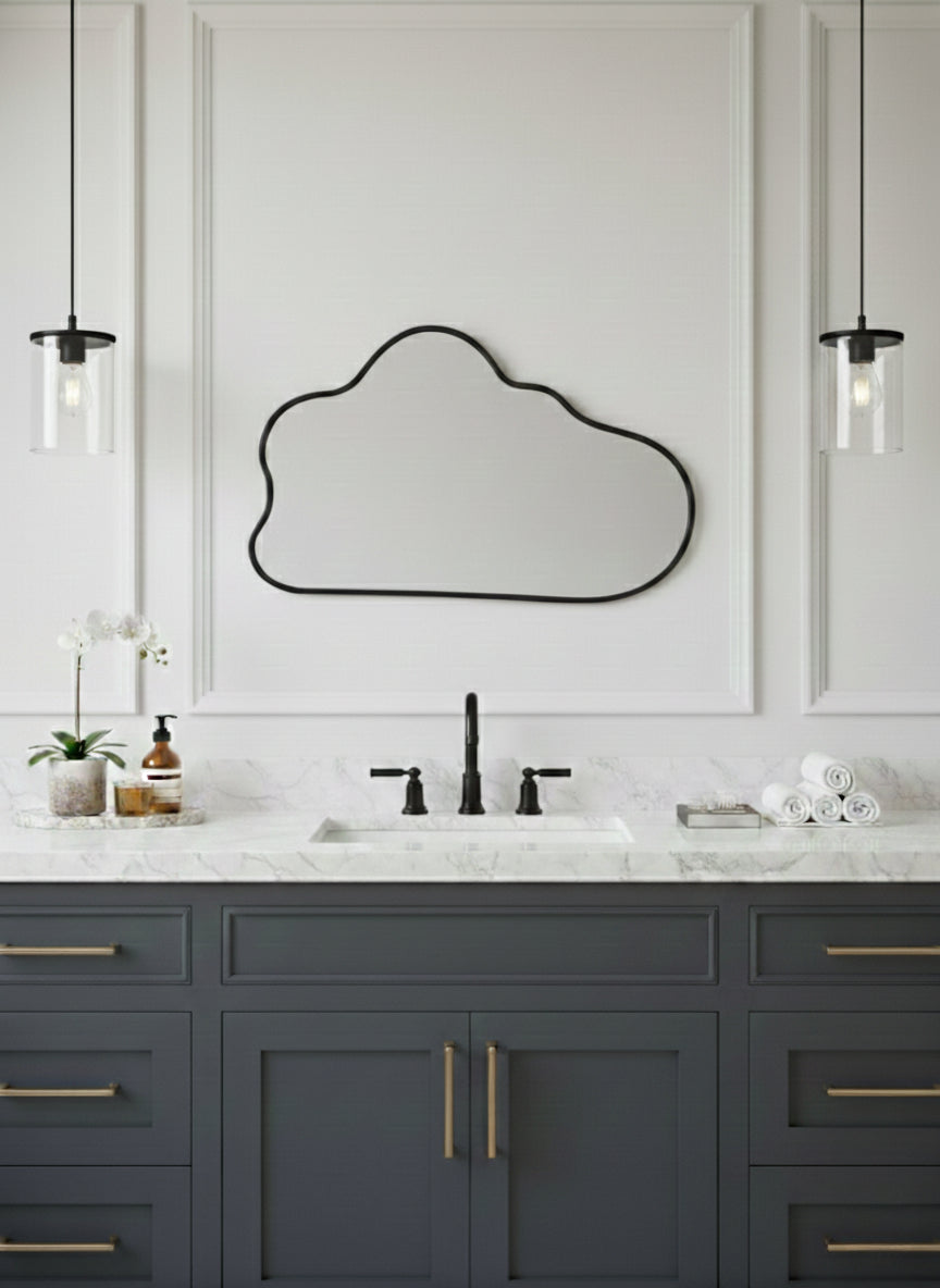 Black irregular mirror above gray vanity.