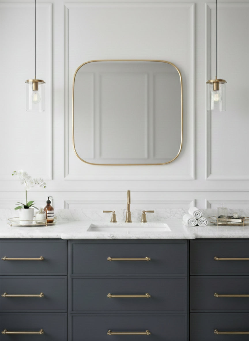 Square brass mirror above bathroom vanity