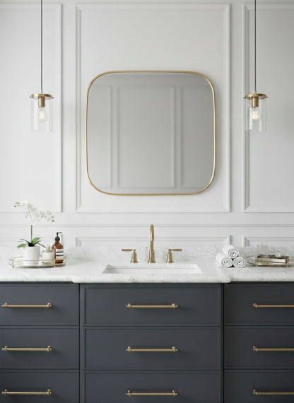 Square brass mirror above bathroom vanity