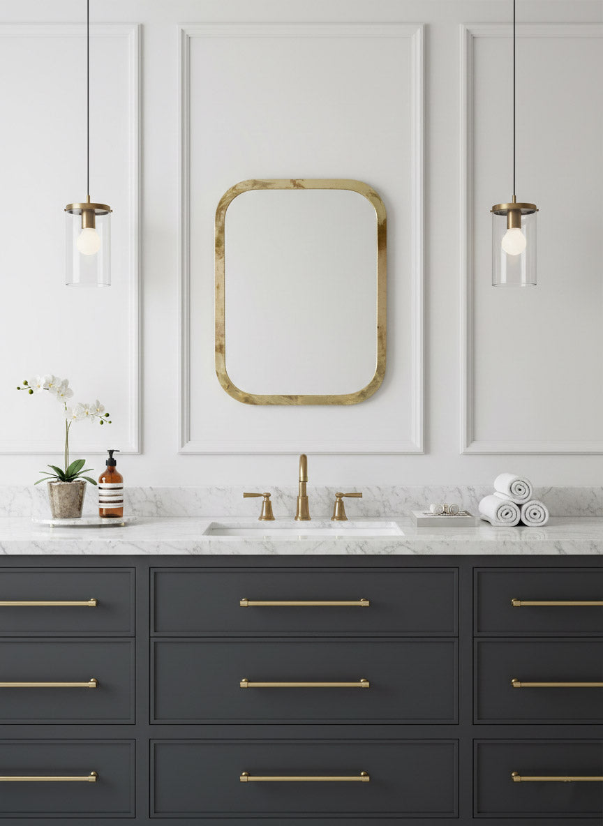 Brass rectangular mirror above classic bathroom vanity