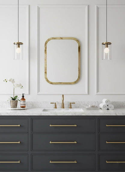 Brass rectangular mirror above classic bathroom vanity