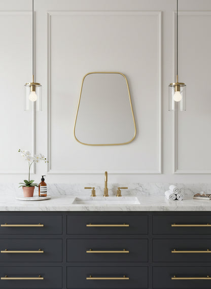 Triangle brass mirror above double vanity with marble countertop