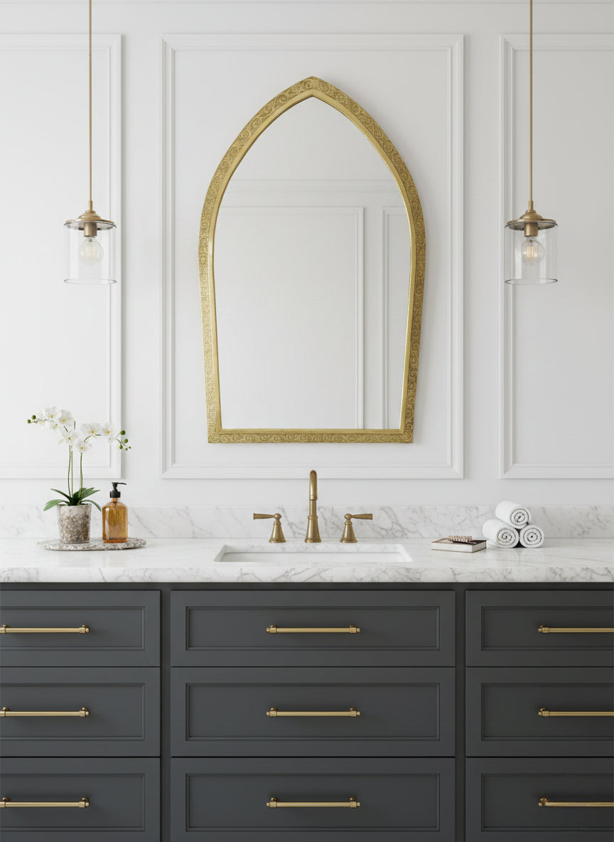  brass mirror above double vanity with marble countertop