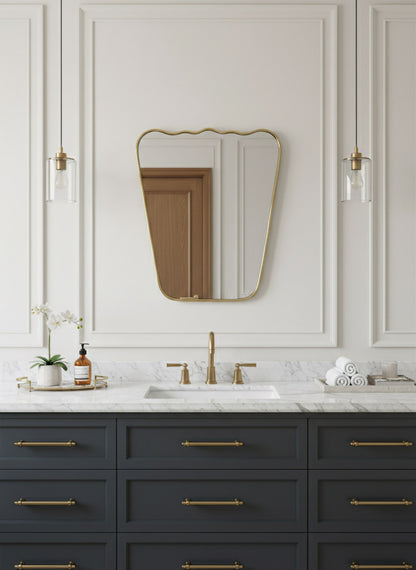 Scalloped brass bathroom mirror above navy blue vanity