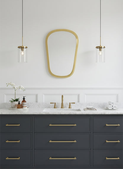 Brass mirror above modern bathroom vanity
