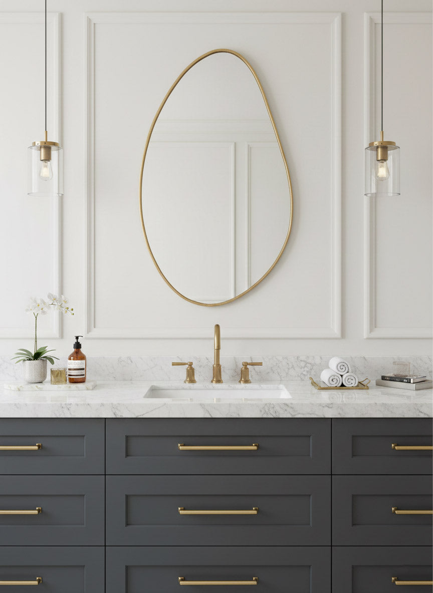 Brass mirror above modern bathroom vanity