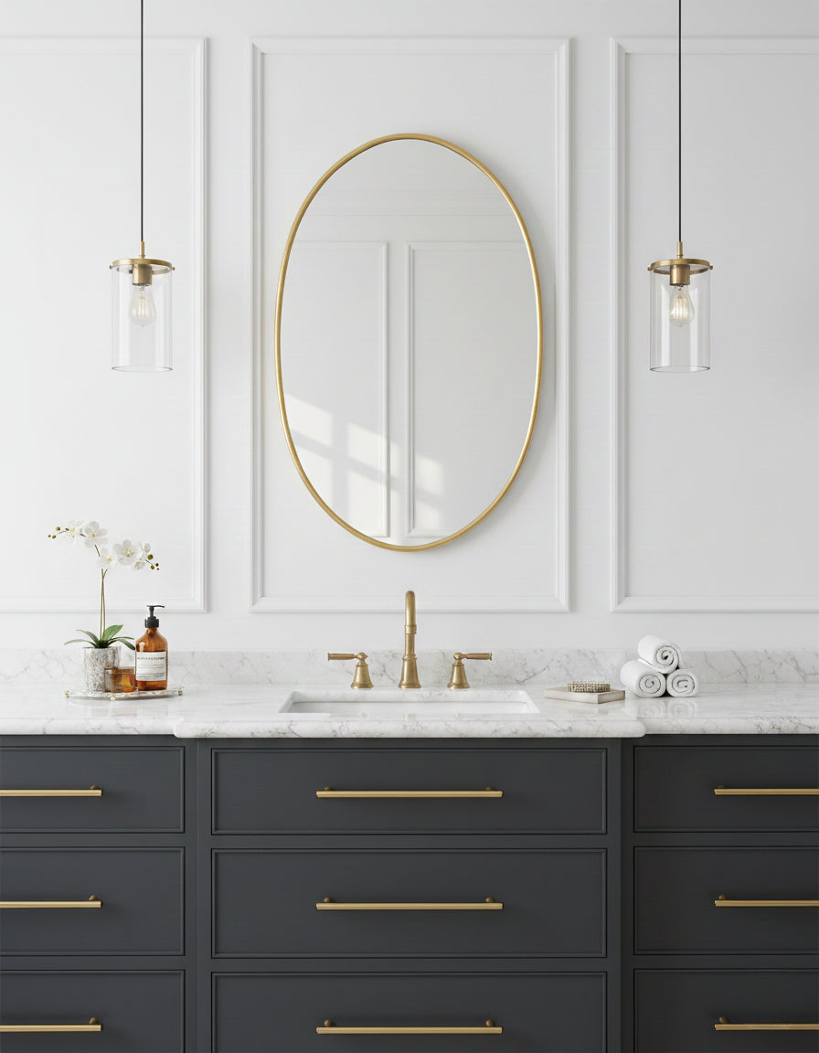 Oval brass mirror above bathroom vanity
