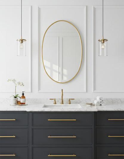 Oval brass mirror above bathroom vanity