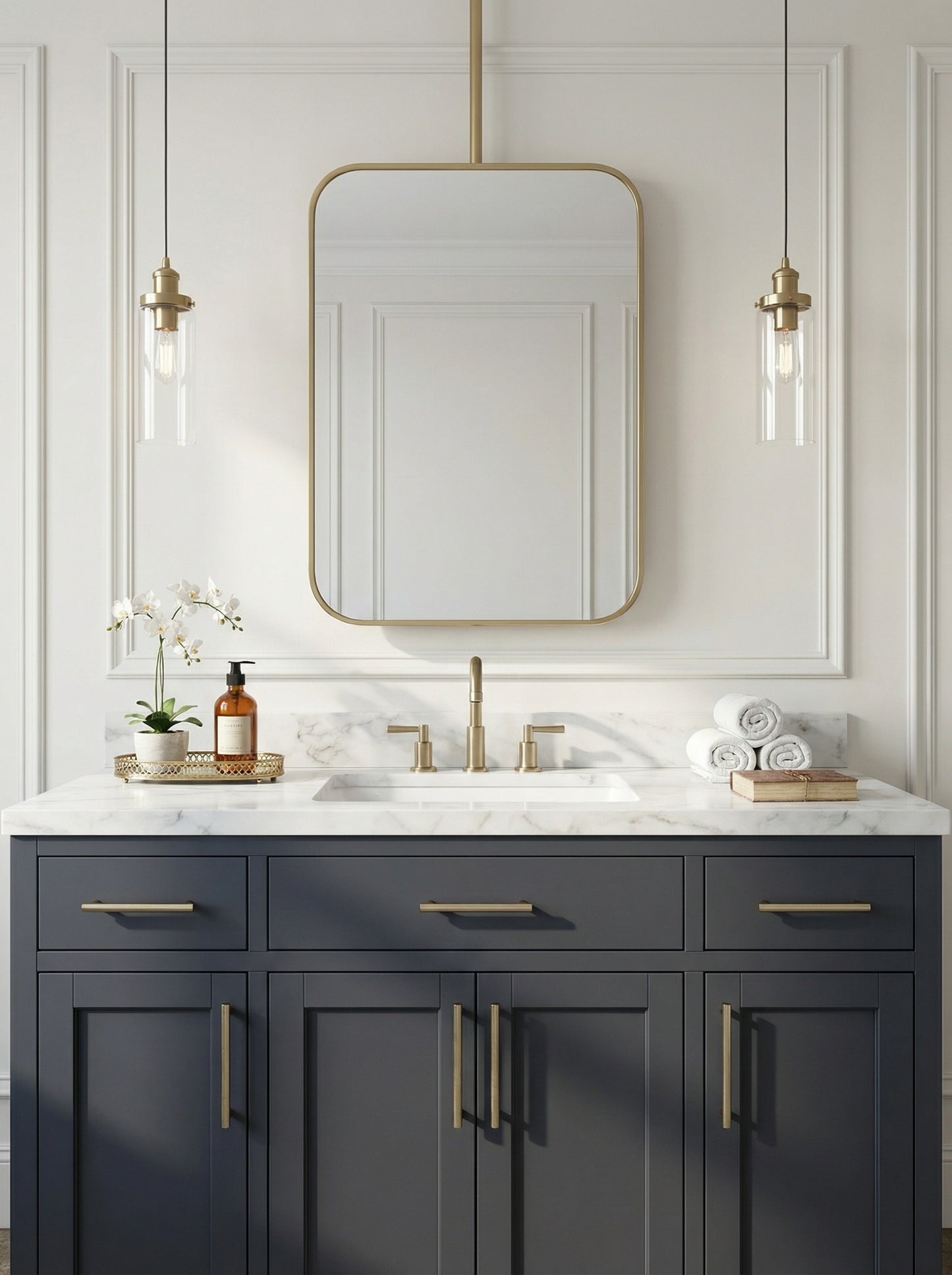 Rounded rectangle brass ceiling mirror above a navy bathroom vanity
