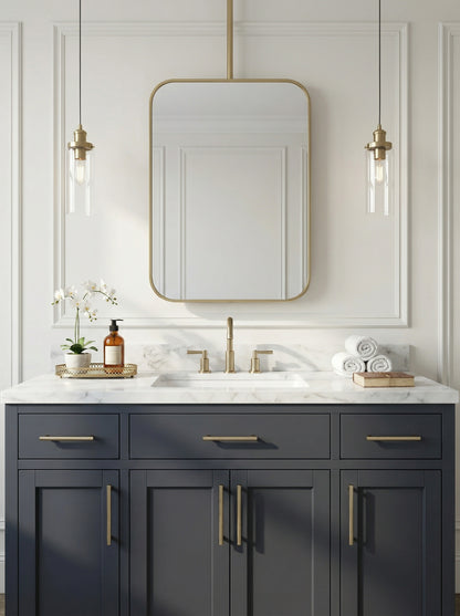 Rounded rectangle brass ceiling mirror above a navy bathroom vanity