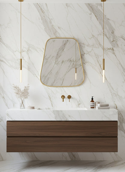 Triangle brass mirror above marble vanity wall