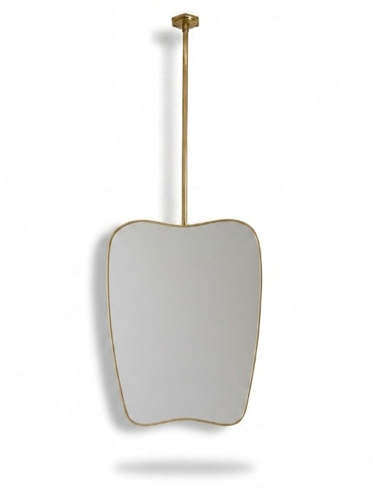 Organic brass hanging mirror with ceiling-mounted rod on white background.