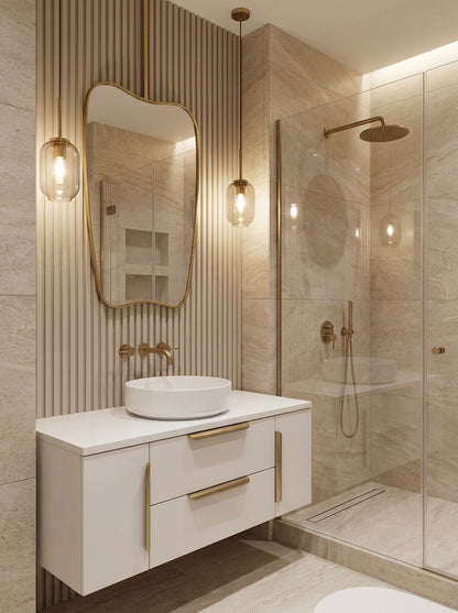 Wavy brass mirror above modern bathroom vanity with pendant lights.