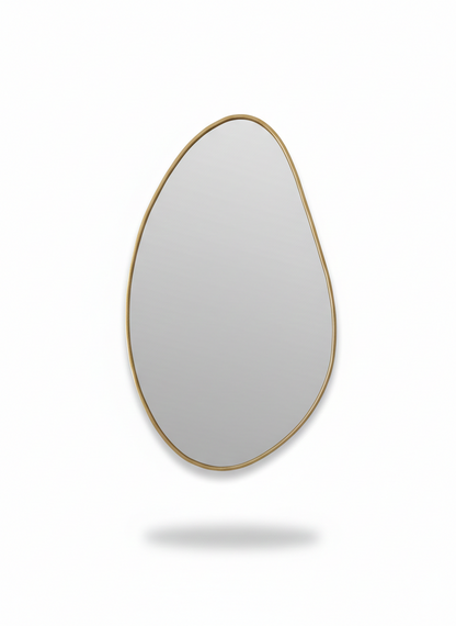 Organic brass wall mirror on white background
