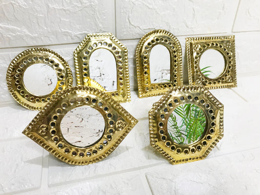 a group of four mirrors sitting on top of a wall