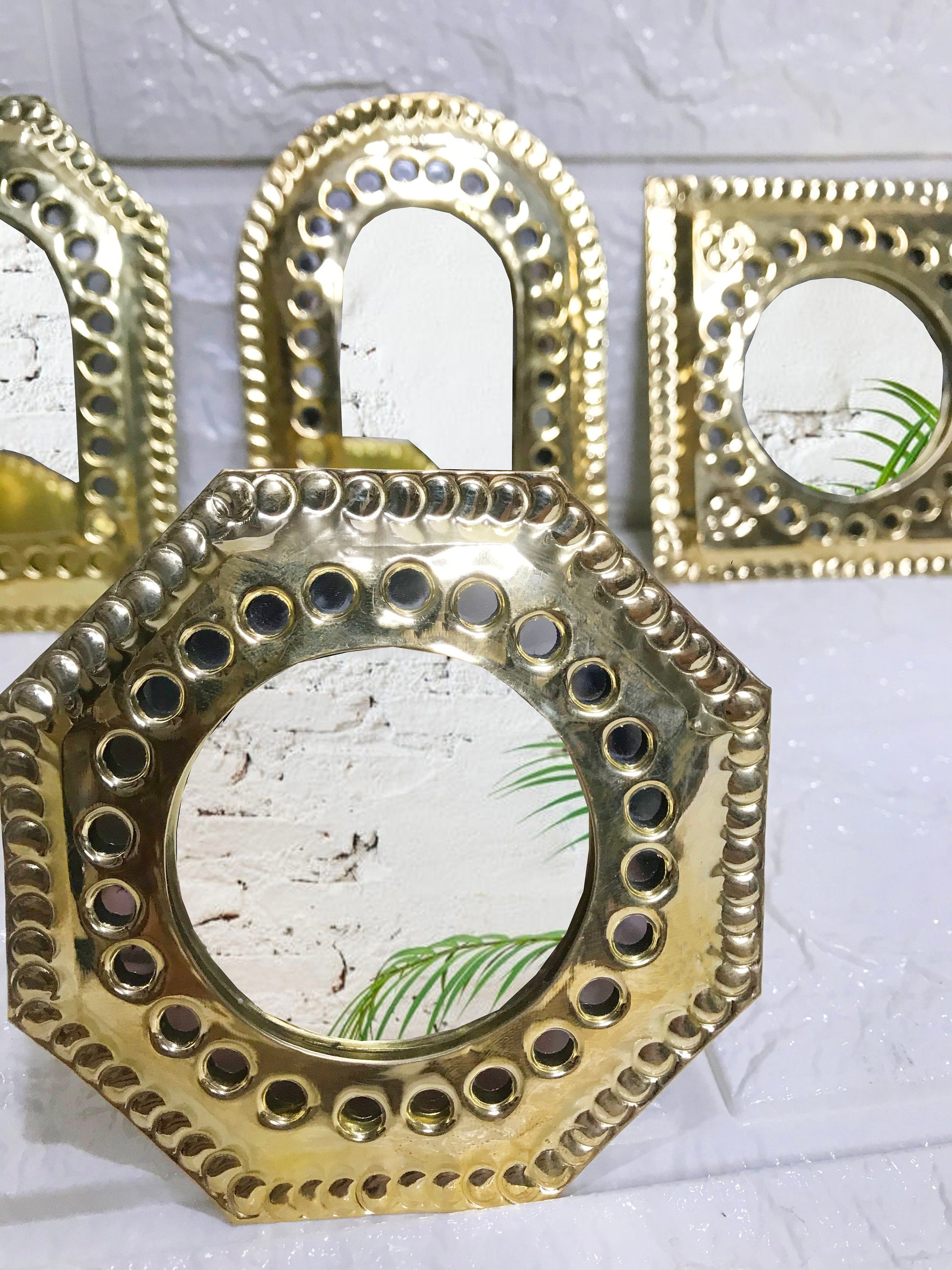 a group of three mirrors sitting on top of a table