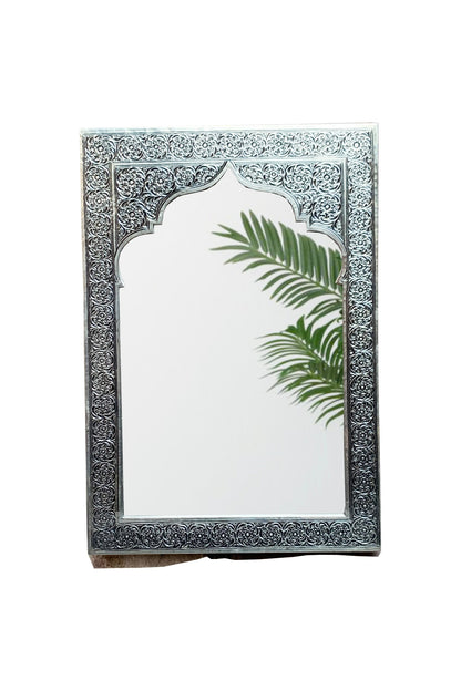 a mirror with a palm leaf on it