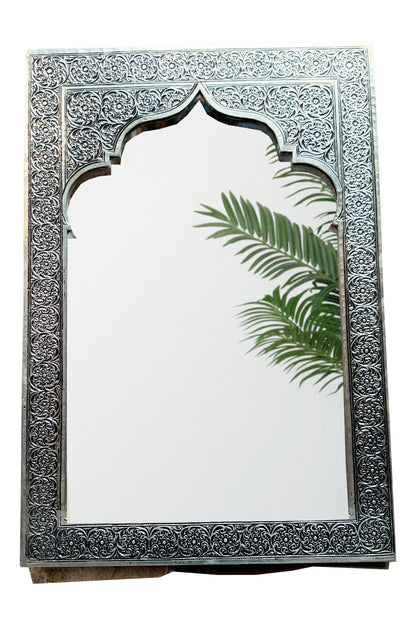 a mirror with a palm leaf on it