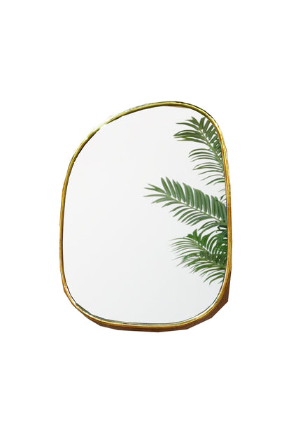 a brass mirror that has a plant in it