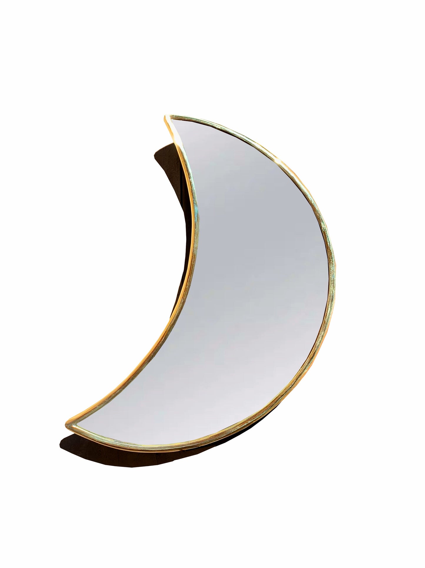 a white and gold crescent shaped mirror on a white background