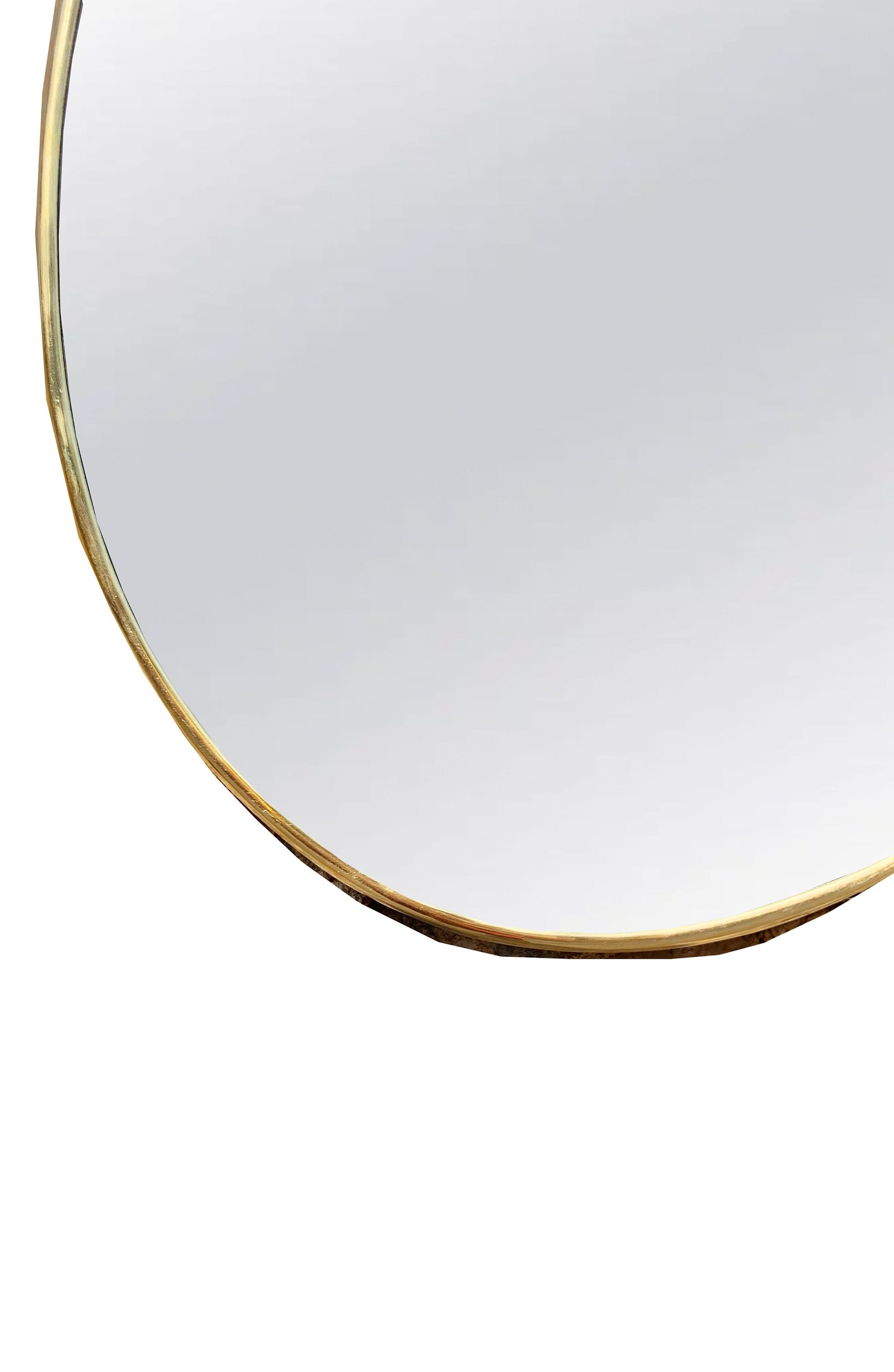 a round mirror with a gold rim on a white background