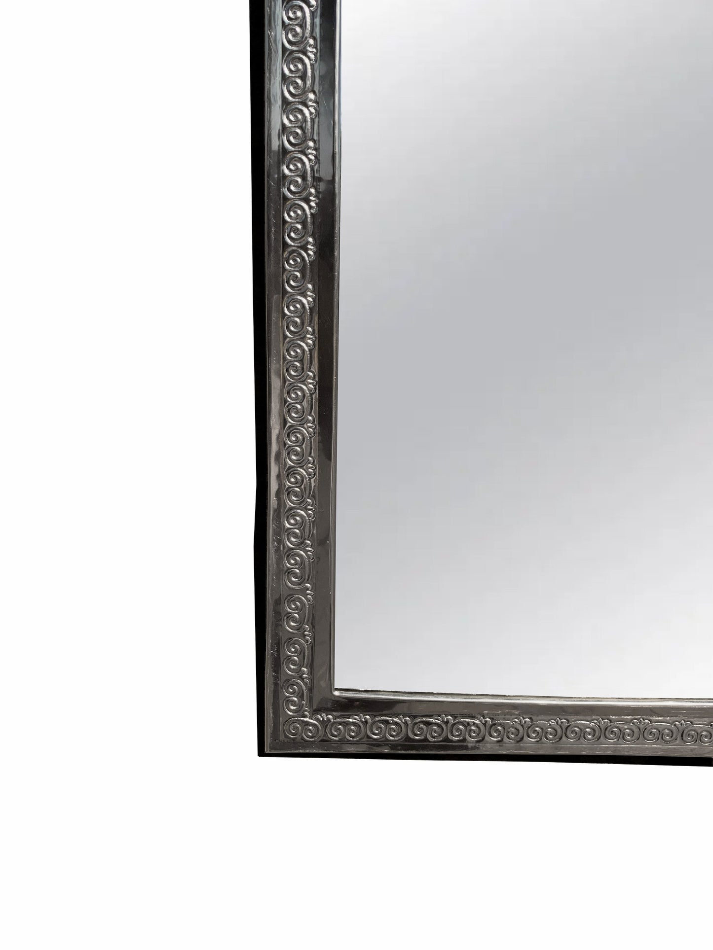 a silver framed mirror on a white wall