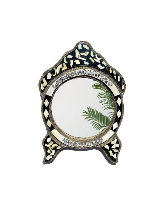 a mirror with a palm leaf on it