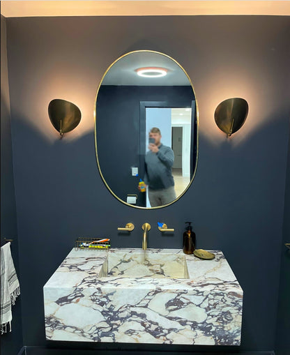 a man taking a picture of himself in a bathroom mirror