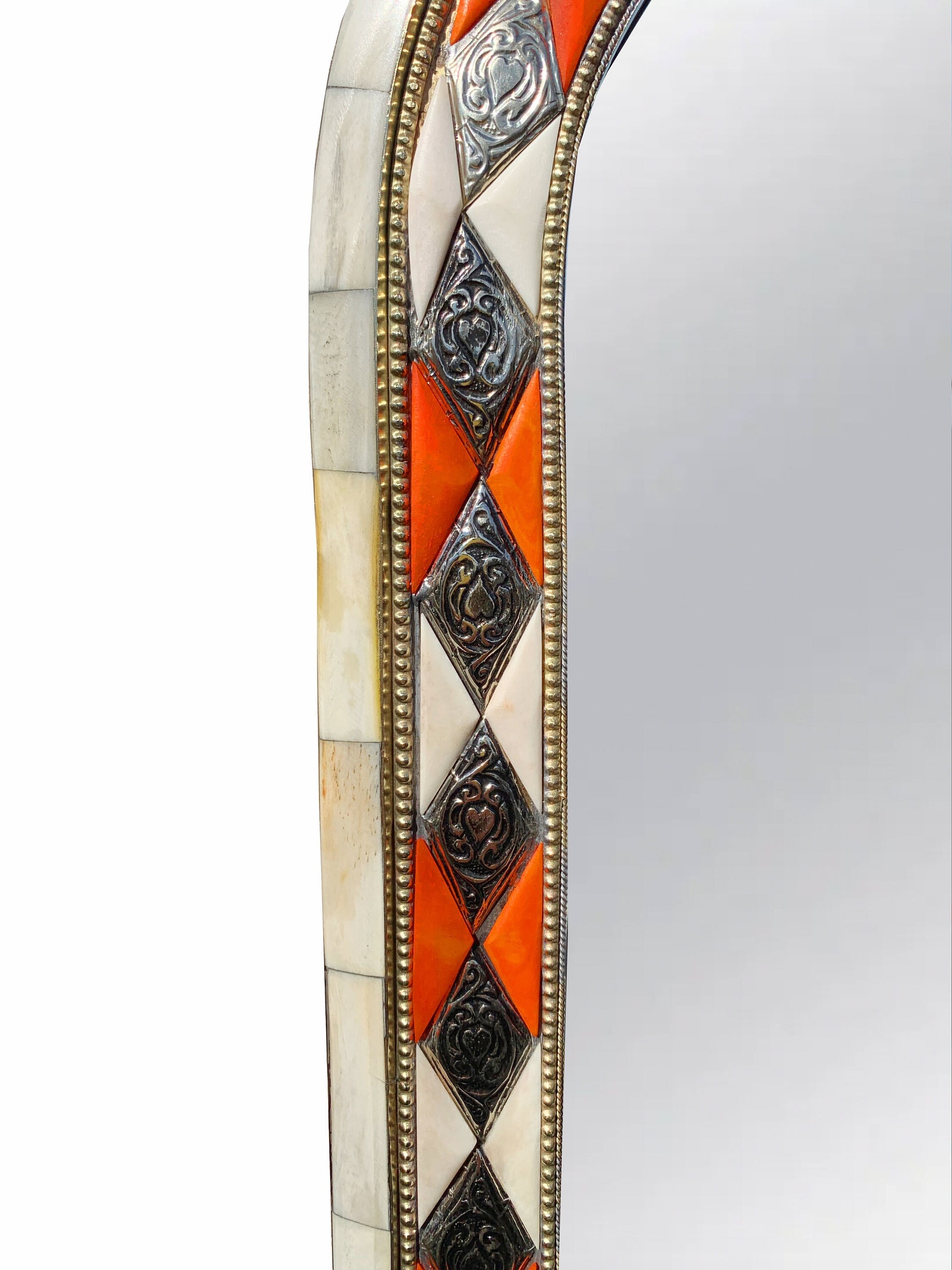 a decorative mirror with an orange and white border