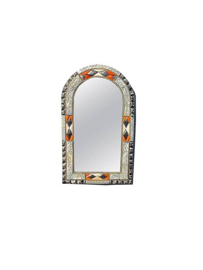 a mirror with an orange and white design on it