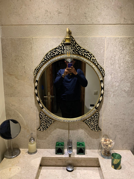 a man taking a picture of himself in a mirror