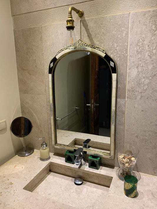 a bathroom sink with a large mirror above it