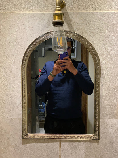 a man taking a picture of himself in a mirror