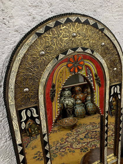 a mirror that is on the side of a wall
