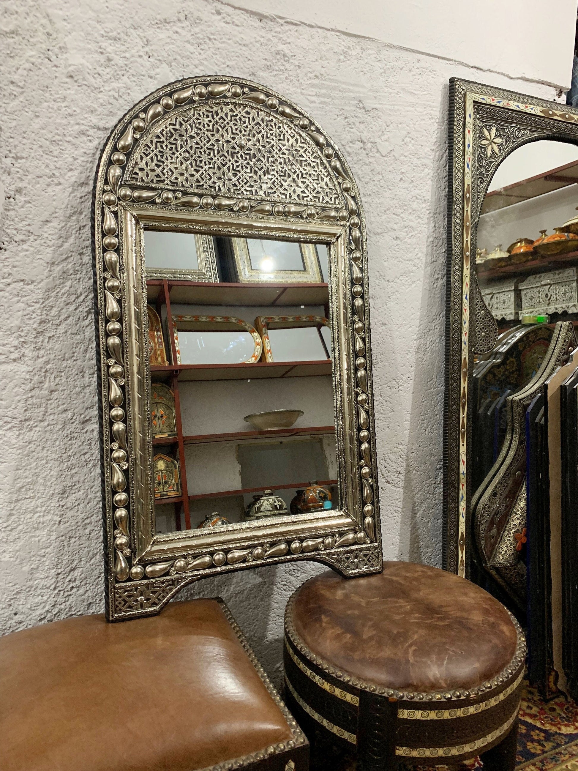 a mirror and a stool in a room