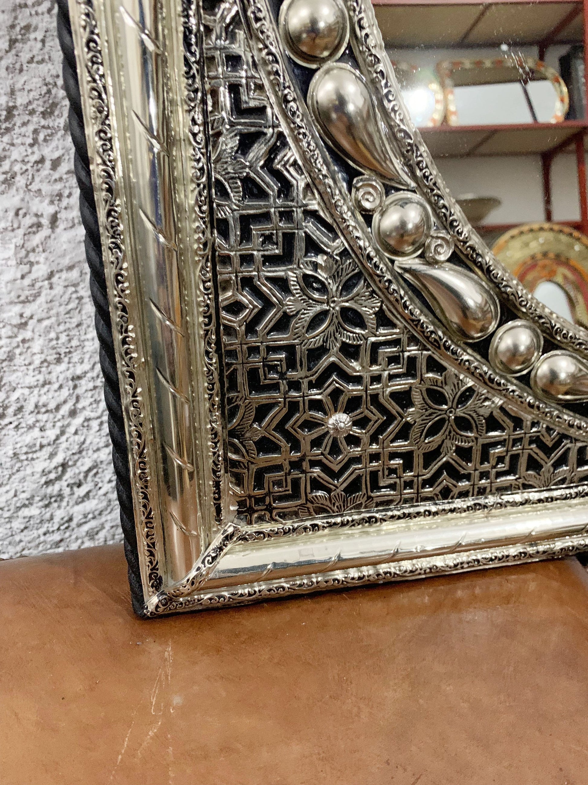 a mirror sitting on top of a wooden table