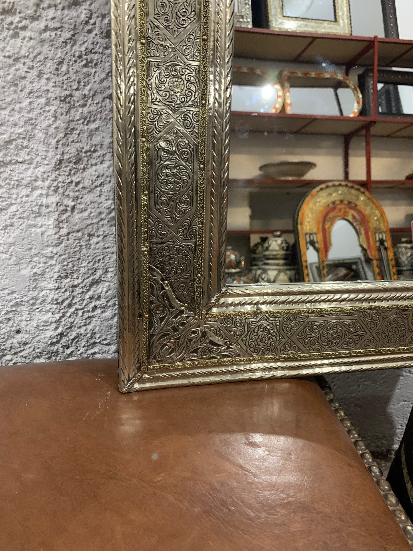 a mirror sitting on top of a wooden table