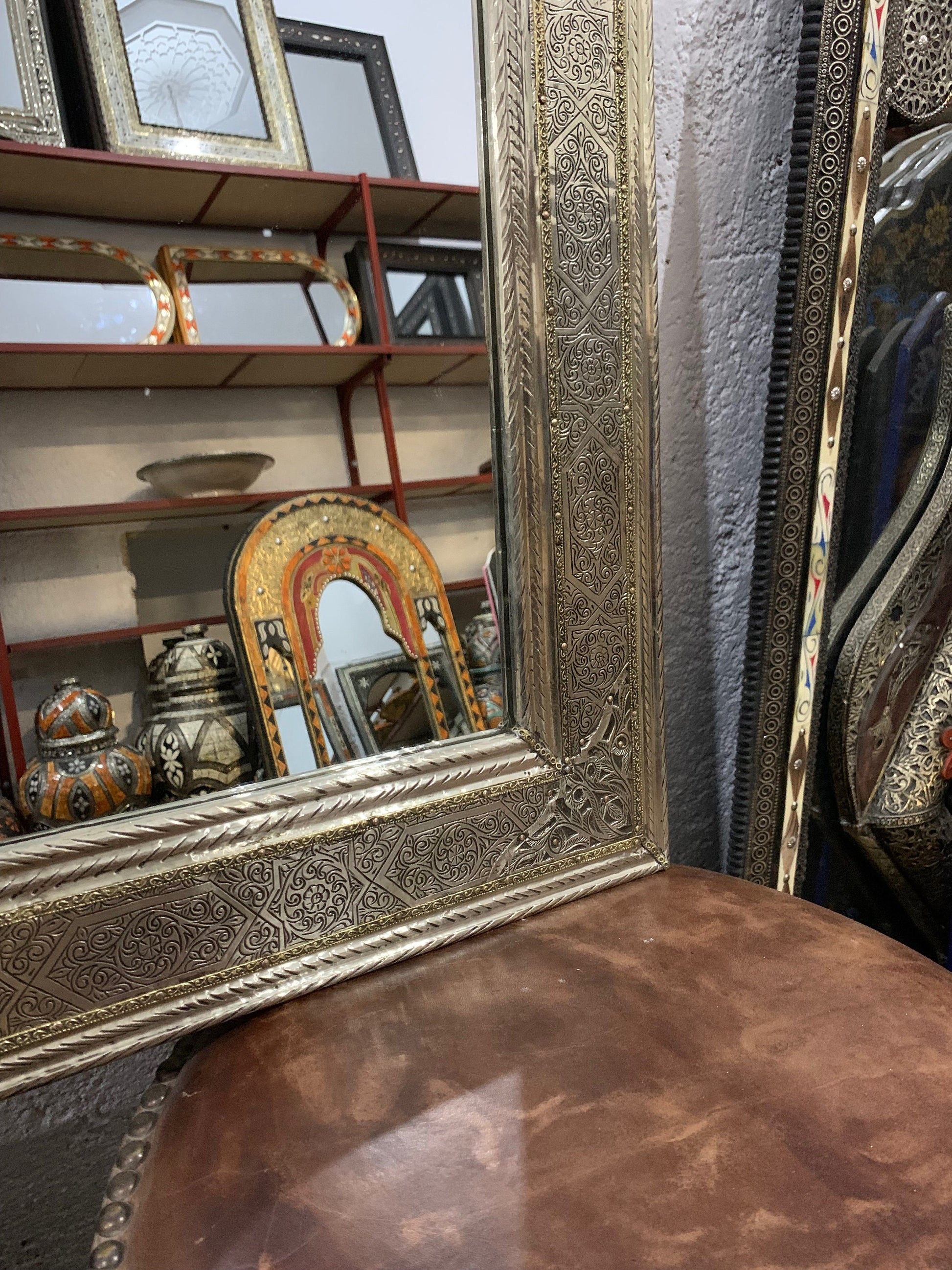 a mirror sitting on top of a wooden table