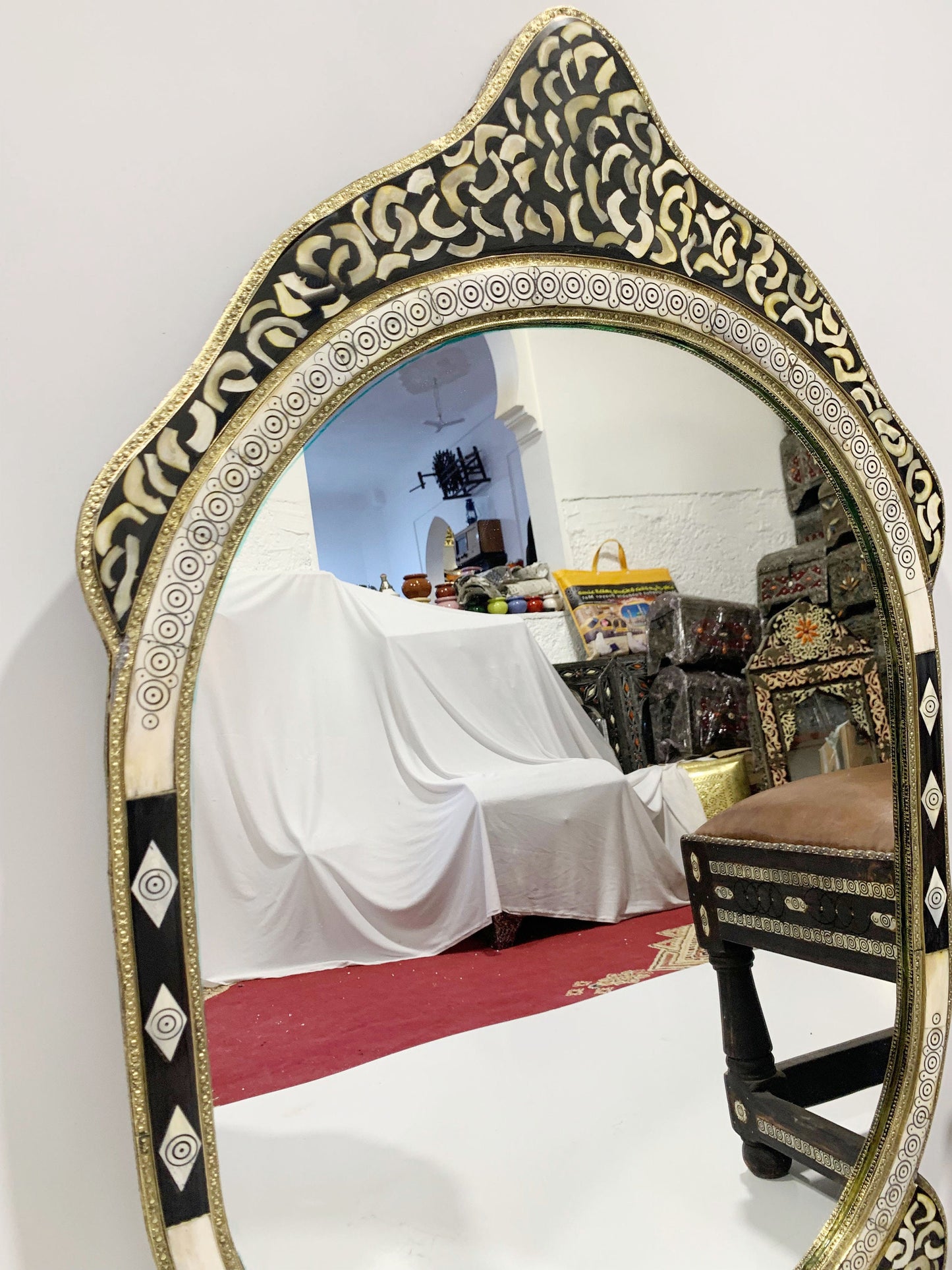 a mirror sitting on top of a table next to a chair