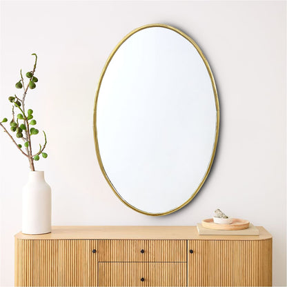 a round mirror sitting on top of a wooden dresser