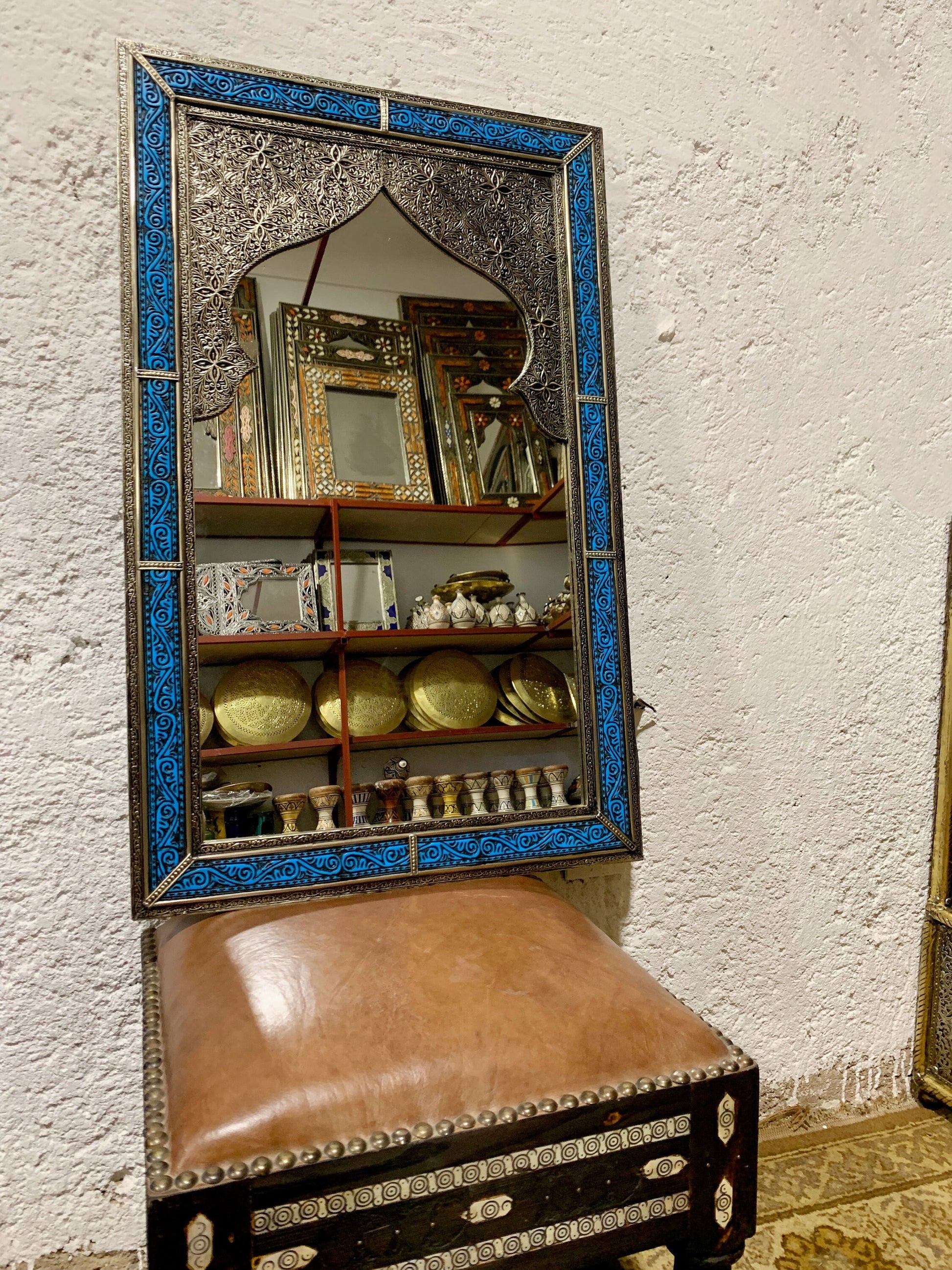 a mirror sitting on top of a wooden bench