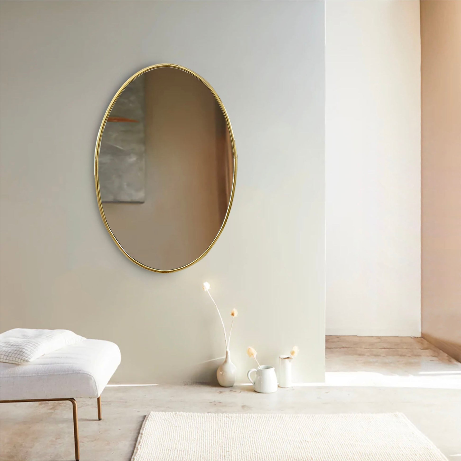 a white chair and a round mirror in a room