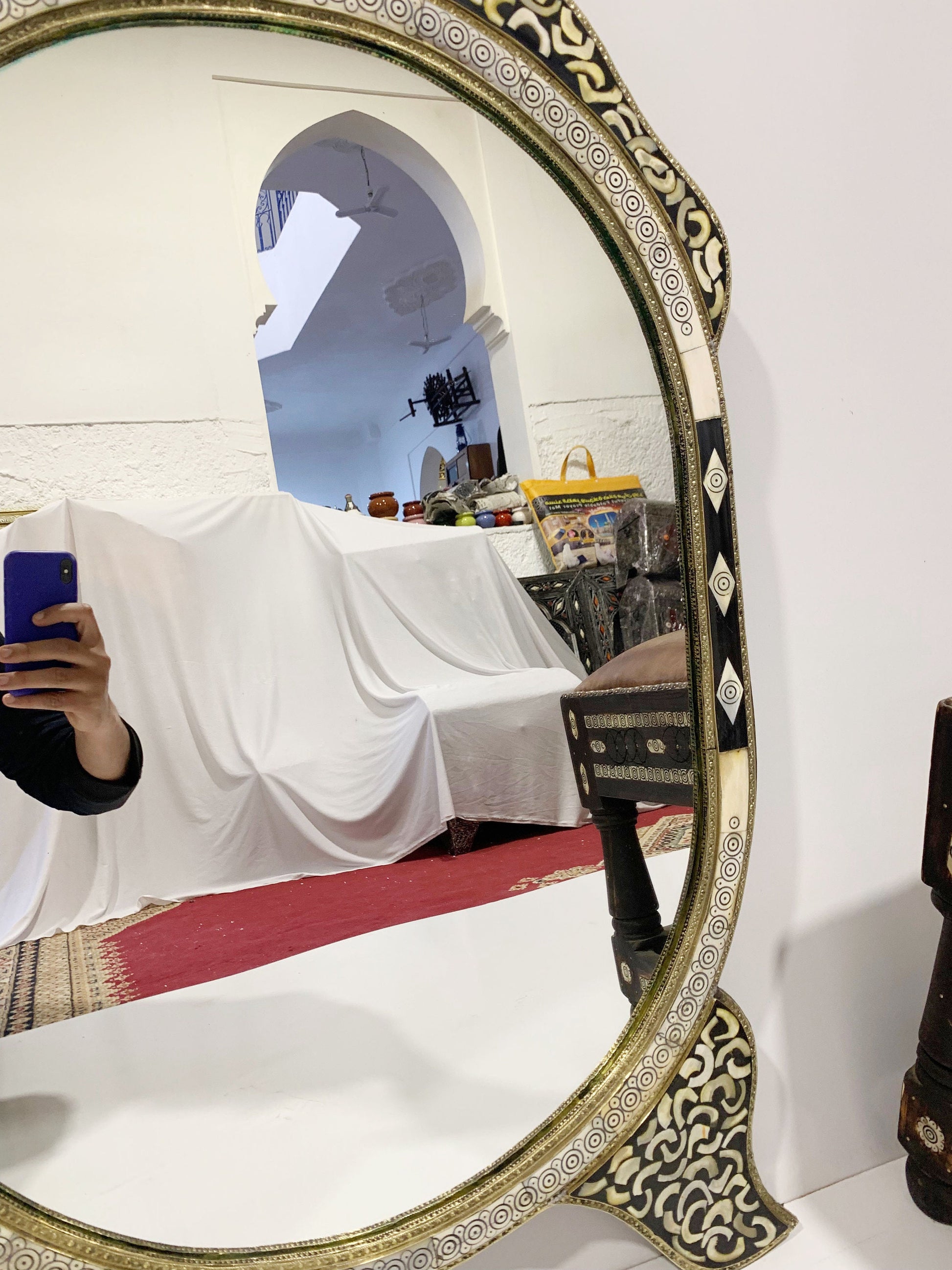 a woman taking a picture of herself in a mirror