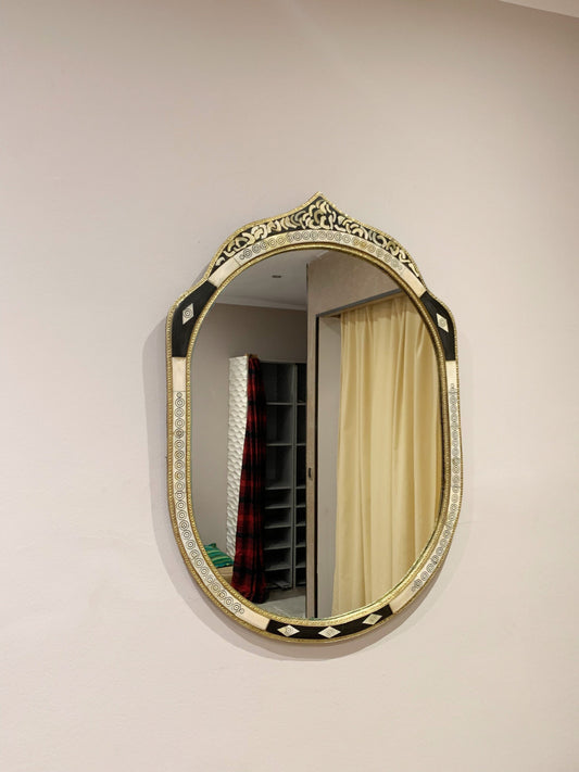 a mirror hanging on the wall above a bed