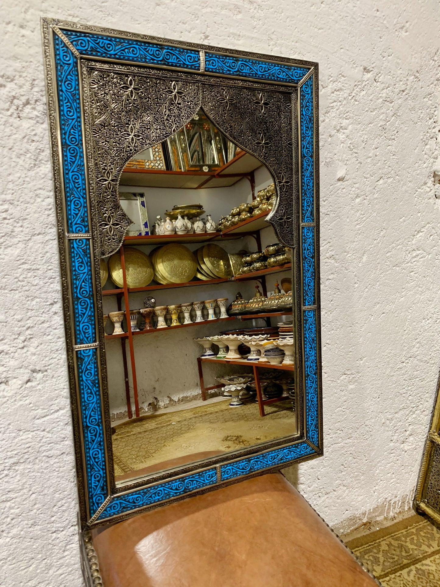 a mirror sitting on top of a wooden bench