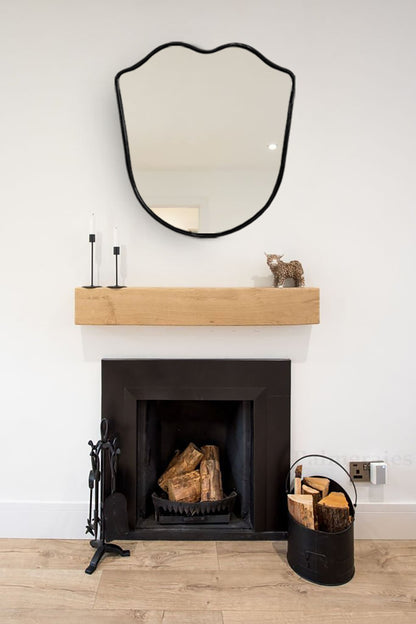 a fire place with a mirror above it