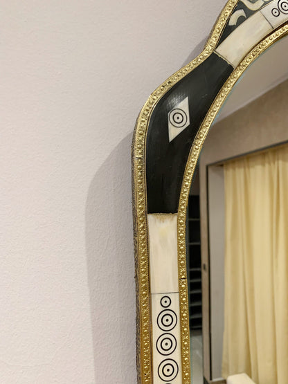 a mirror with a black and white design on it