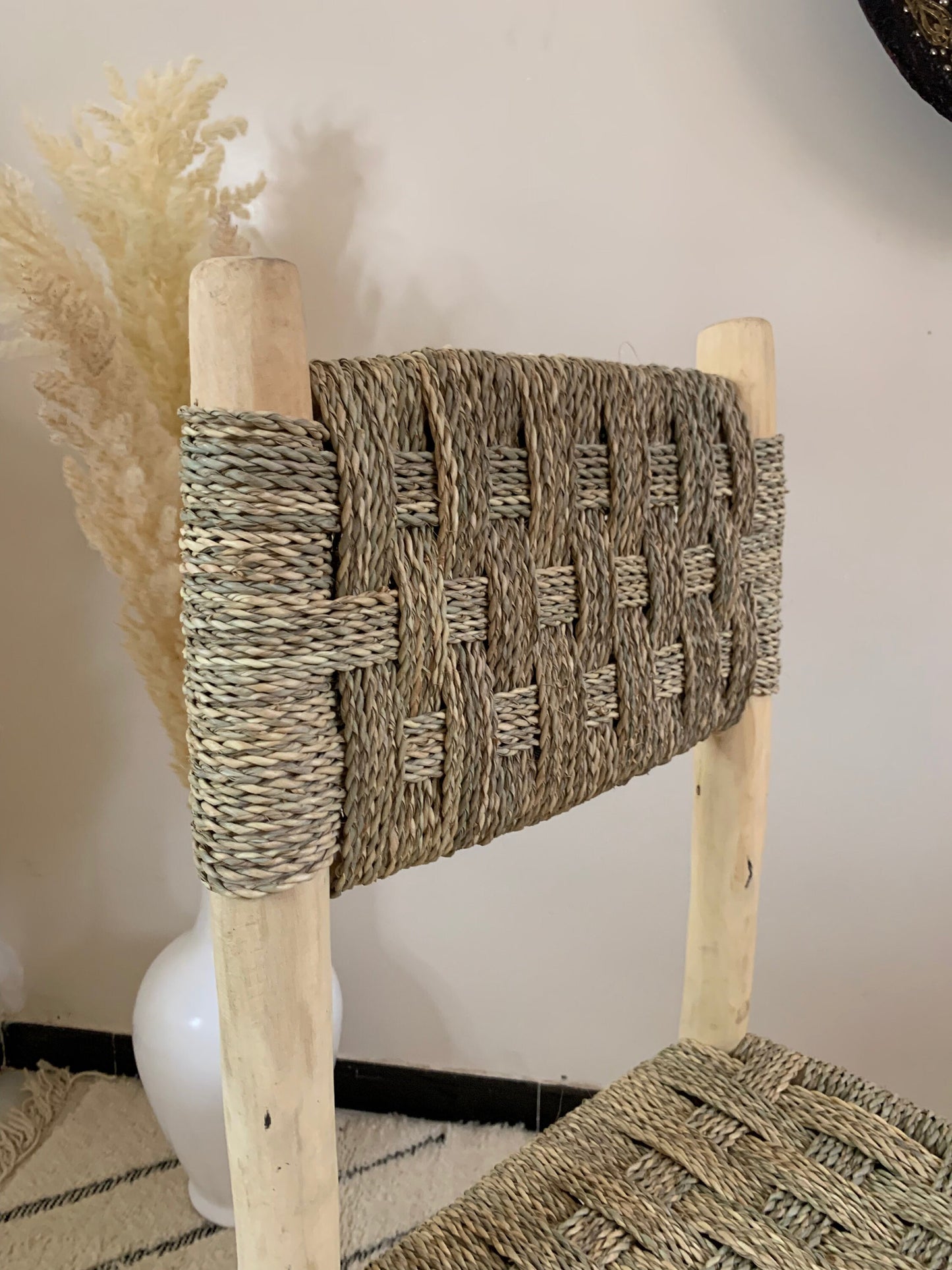 a chair with a woven seat and wooden legs