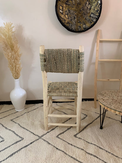 a chair and a vase in a room