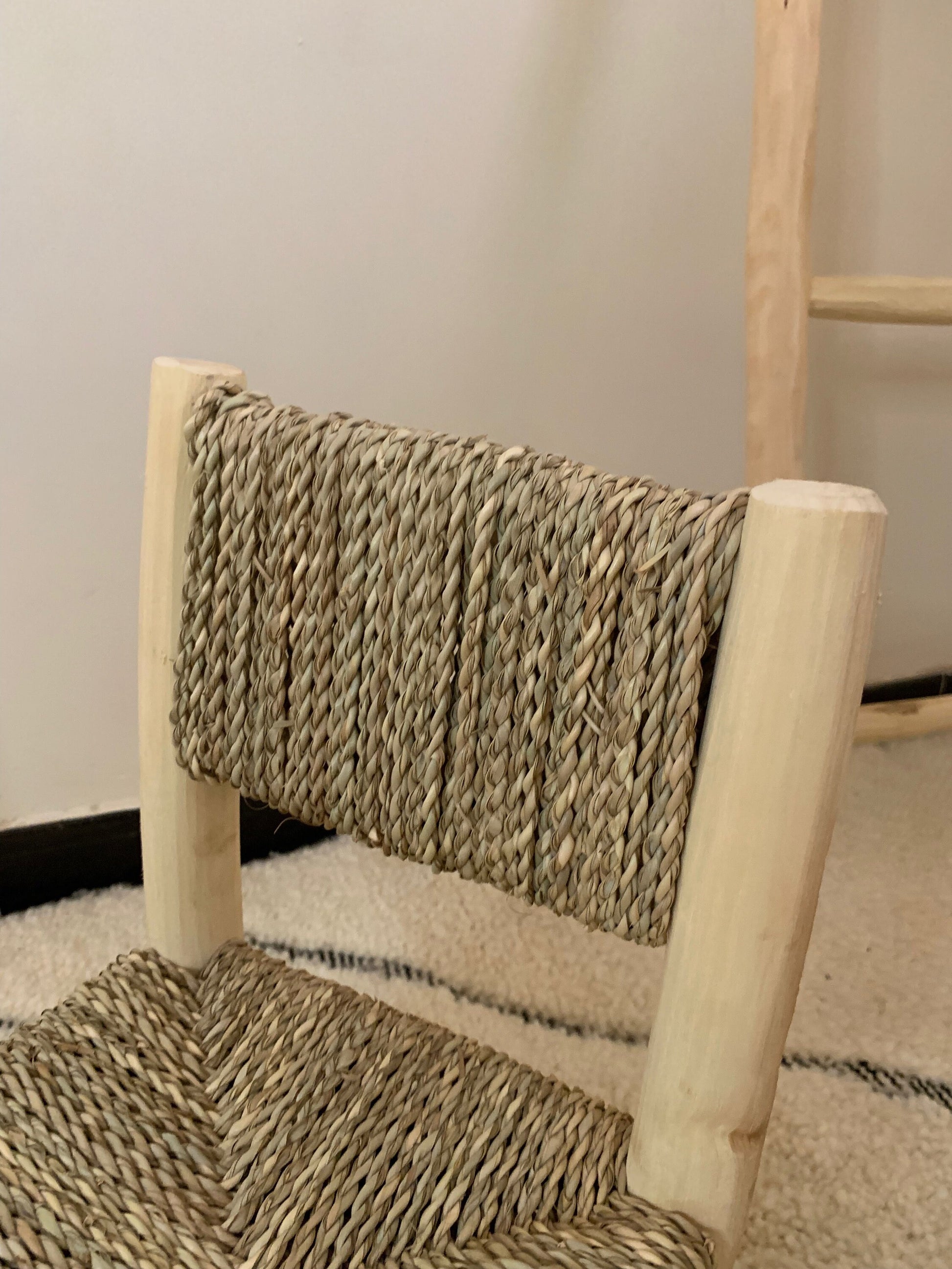 a wooden chair with a woven seat and back